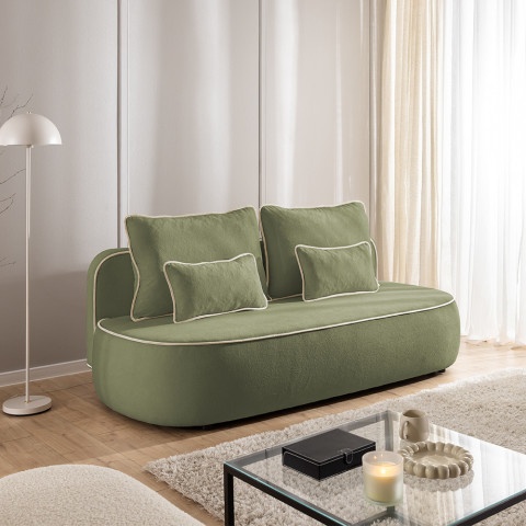 Sofa z funkcją spania Bali zielona pluszowa z ozdobną lamówką i poduszkami