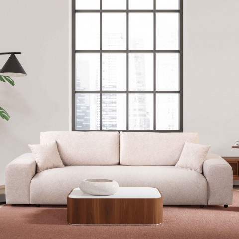 Beżowa sofa do salonu – Candi, czteroosobowa, z poduszkami i praktyczną funkcją spania